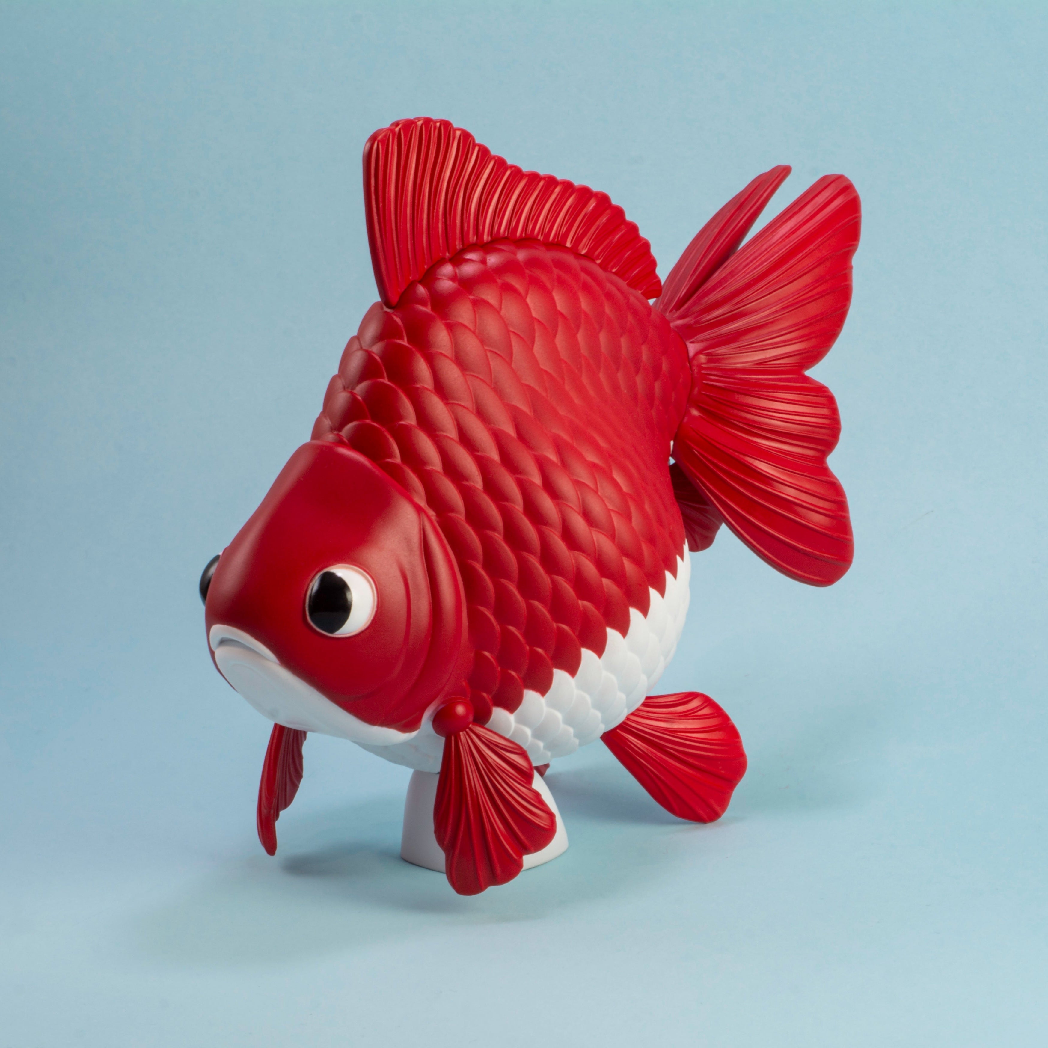 Ryukin Goldfish model - Red and white fish-shaped toy on a light blue background