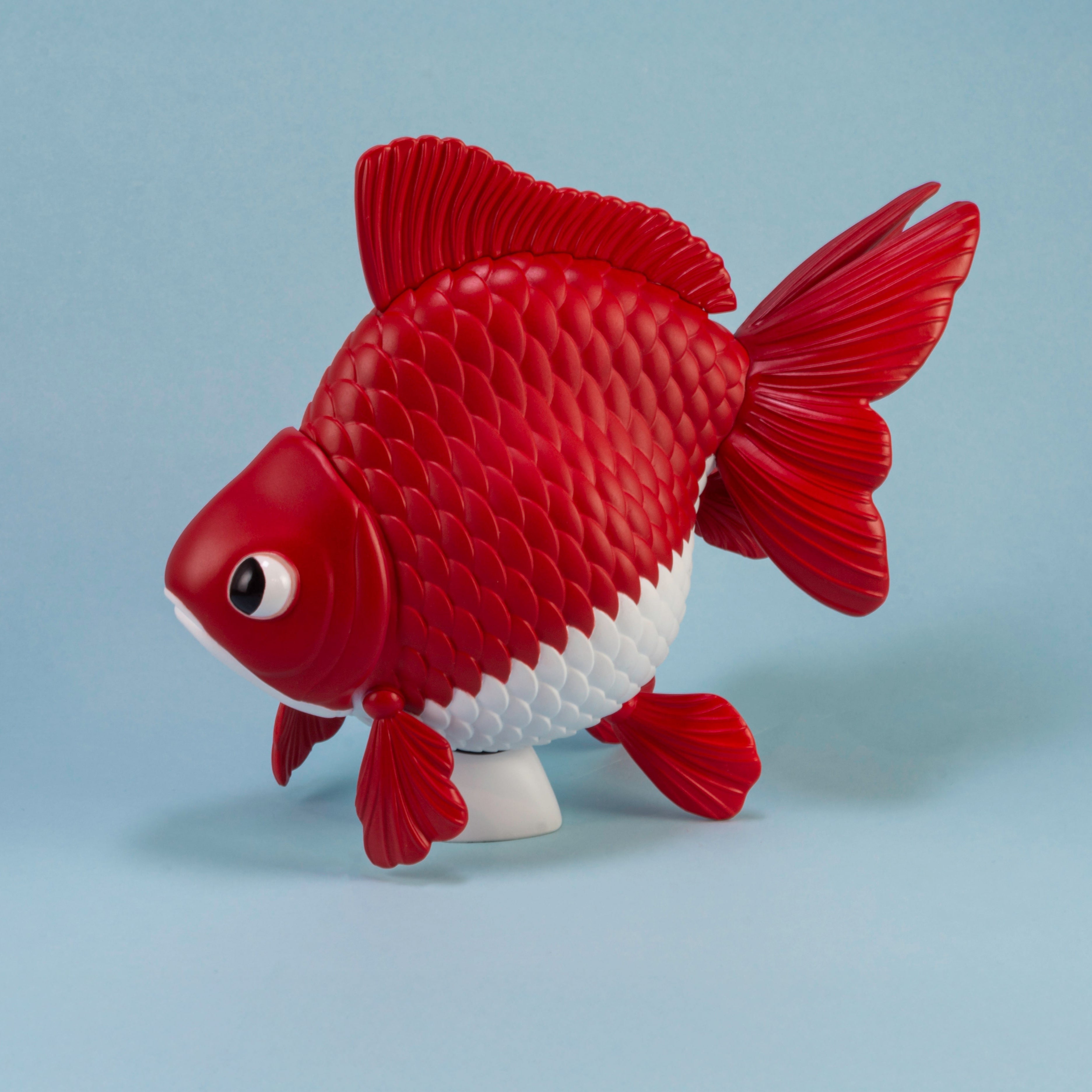 Ryukin Goldfish model. Red and white fish-shaped toy on a light blue background side profile showing fins and round body